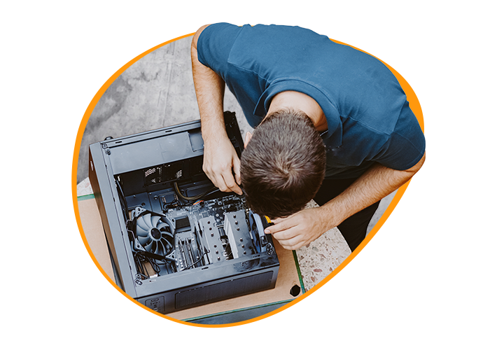 Birdseye shot of a young I.T. professional assempling a computer.