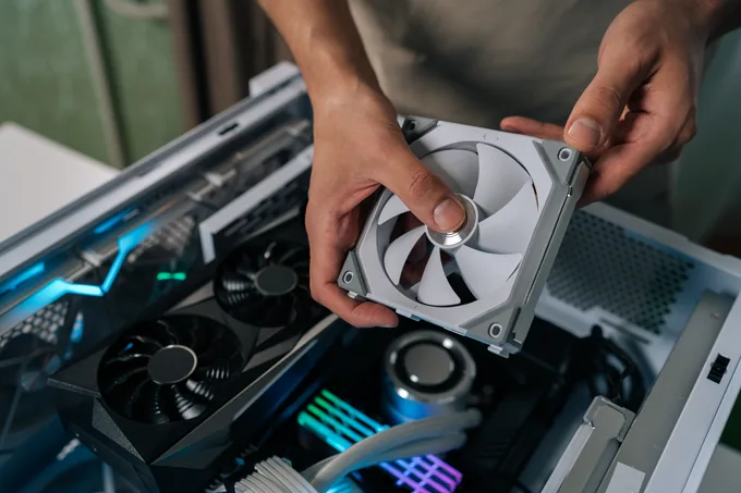 A builder fitting a case fan